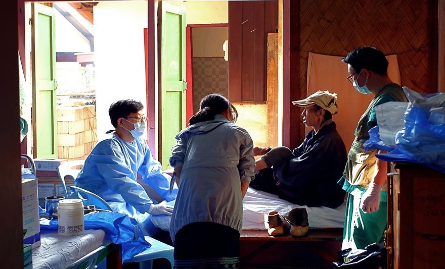 Prof. Leu Dae Hyeon(Plastic Surgery) is providing wound care to a patient with Hansen's disease in 'Somssaneuk' near Vang Vieng in Laos.